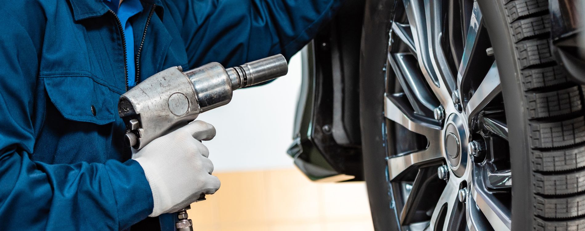 Technician servicing a tire in a service shop